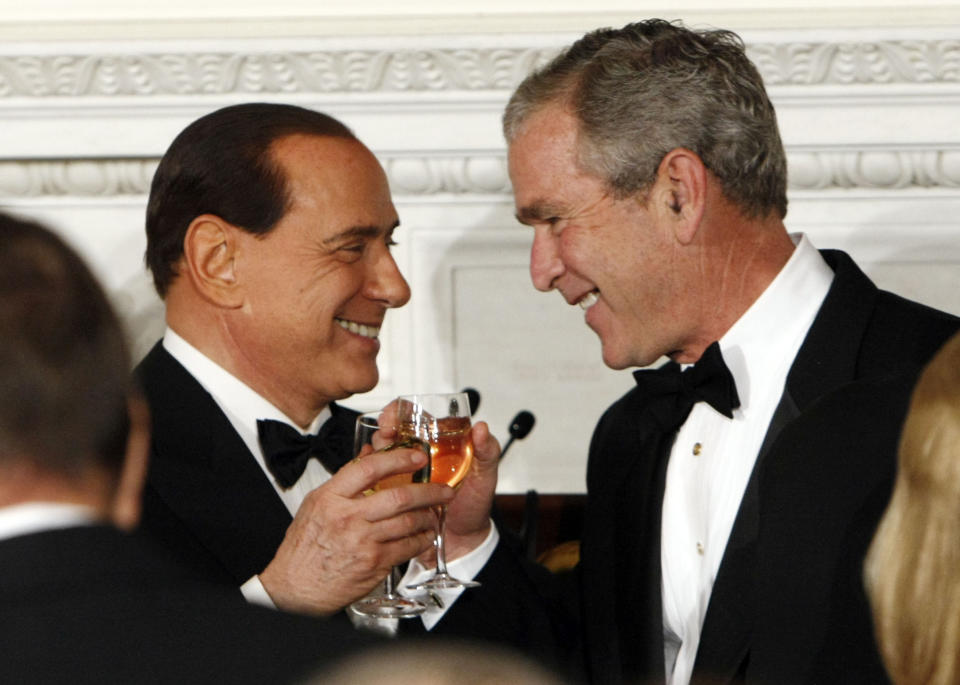 FILE - In this Monday, Oct. 13, 2008 file photo President George Bush, right, toasts with the Prime Minister of Italy Silvio Berlusconi during an Official Dinner in the State Dining Room in Washington. Berlusconi, the boastful billionaire media mogul who was Italy's longest-serving premier despite scandals over his sex-fueled parties and allegations of corruption, died, according to Italian media. He was 86. (AP Photo/Pablo Martinez Monsivais, File)