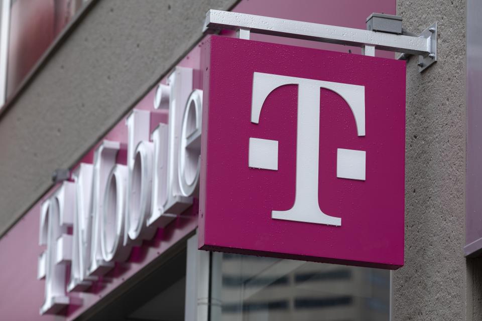 FILE - The T-Mobile logo is seen on a storefront, Oct. 14, 2022, in Boston. On Friday, Jan. 5, 2024, The Associated Press reported on stories circulating online incorrectly claiming T-Mobile is going to fine individual consumers for texting about topics that fall under the categories of sex, hate, alcohol, firearms or tobacco. (AP Photo/Michael Dwyer, File)