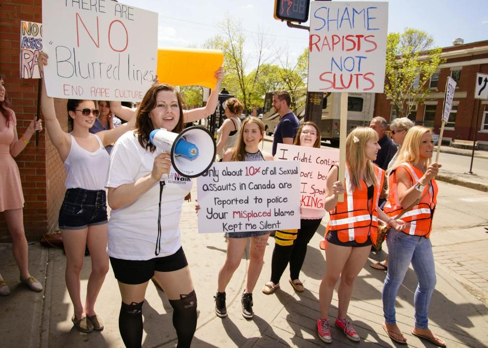 a group of women protesting rape culture and holding placards