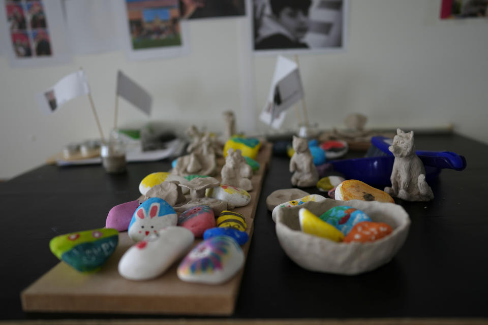 Painted rocks in a childrens workroom at the Ukraine village, which has been constructed for Ukrainian families fleeing the war, in Linkeroever, Belgium, Friday, March 17, 2023. Despite the warm welcome for millions of Ukraine refugees on European Union soil since the Russian invasion, EU officials said Tuesday, June 6, 2023 that there are some fears of wavering support caused by a bad economy hitting poor families especially and the creeping influence of Russian propaganda. (AP Photo/Virginia Mayo)