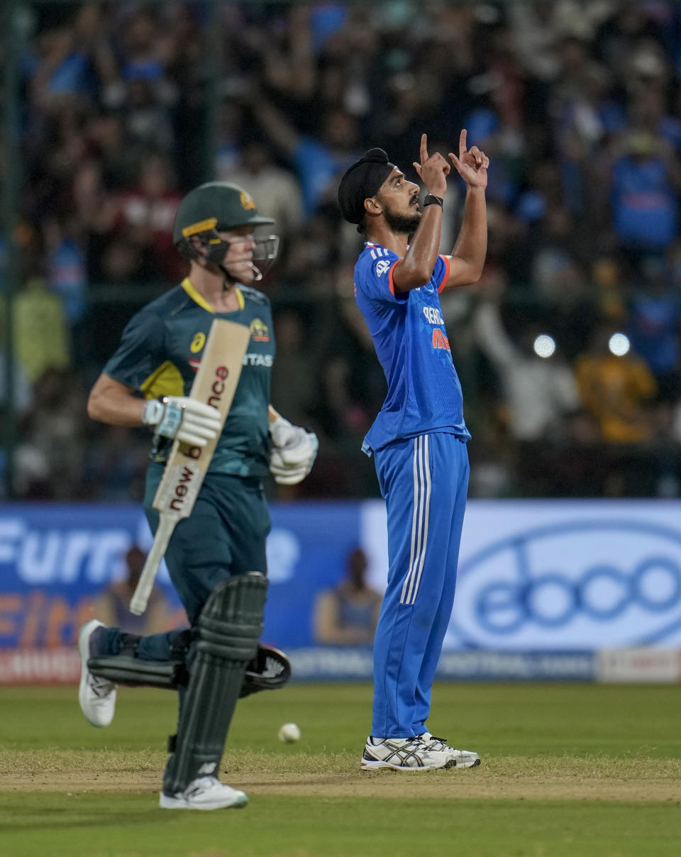 India's Arshdeep Singh, right, celebrates after bowling the last delivery to win the fifth T20 cricket match against Australia in Bengaluru, India, Sunday, Dec. 3, 2023. (AP Photo/Aijaz Rahi)