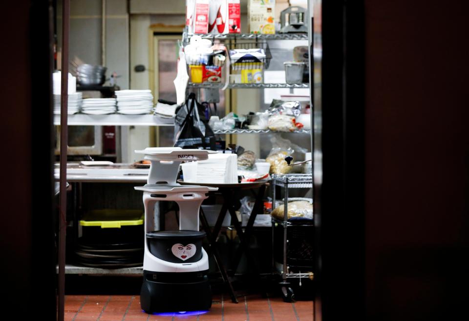 A robot food server know as "Rosey" waits for food to deliver to a table at Archie's Italian Eatery on East Republic Road on Tuesday, June 14, 2022. 