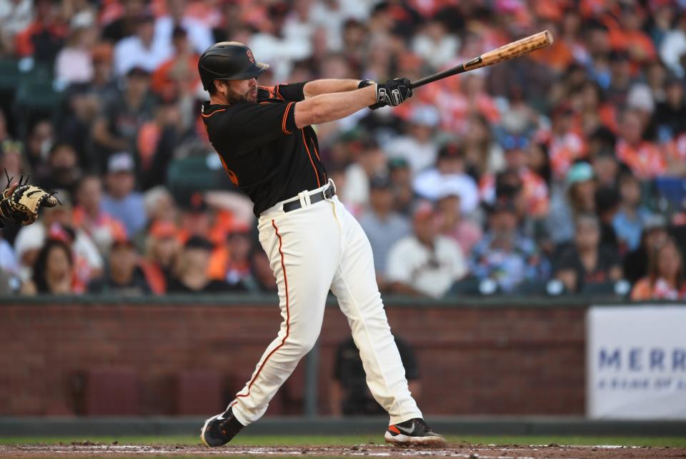 Darin Ruf of the San Francisco Giants swings and connects for a home run against Eric Lauer in the bottom of the sixth inning at Oracle Park on Saturday.