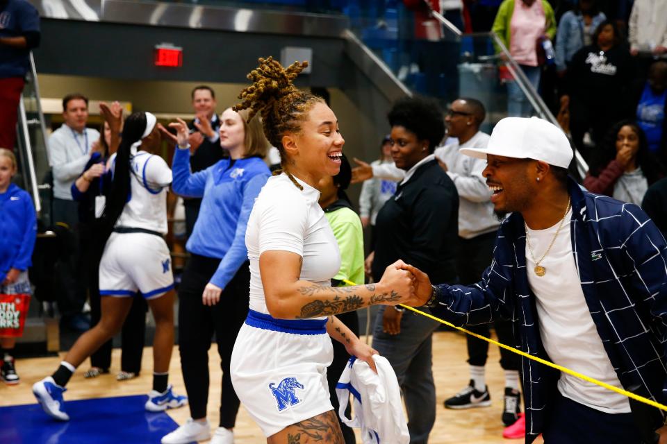 Memphis' Madison Griggs celebrates with a fan after they won against Jackson State 79-68 in the first round of the WNIT.