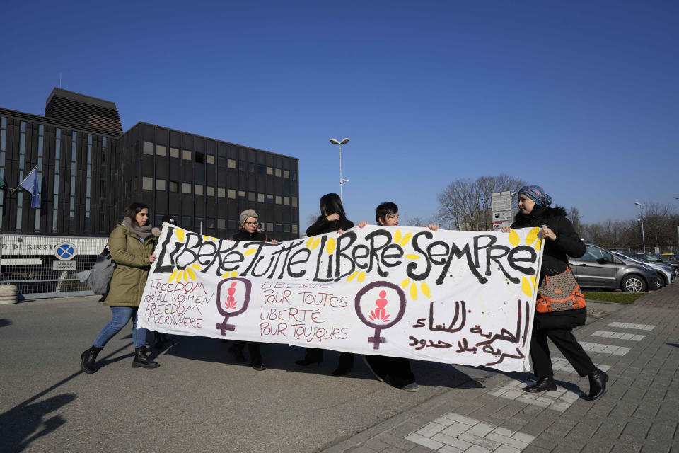 Activists of the 'Trama di Terre' (Weaving of Native Lands) and other women's advocacy groups display a banner in Italian reading 'Freedom for all women, forever free', outside the Reggio Emilia courthouse in northern Italy, during the opening session of trial for the alleged murder of Pakistani-born Saman Abbas Friday, Feb.10, 2023. Courageous refusal by young immigrant women in Italy to submit to forced marriages sometimes carries a deadly price. In two murder trials this month, Italian prosecutors are seeking justice for Pakistani immigrant women allegedly killed because they refused marriages imposed by their parents. (AP Photo/Luca Bruno)