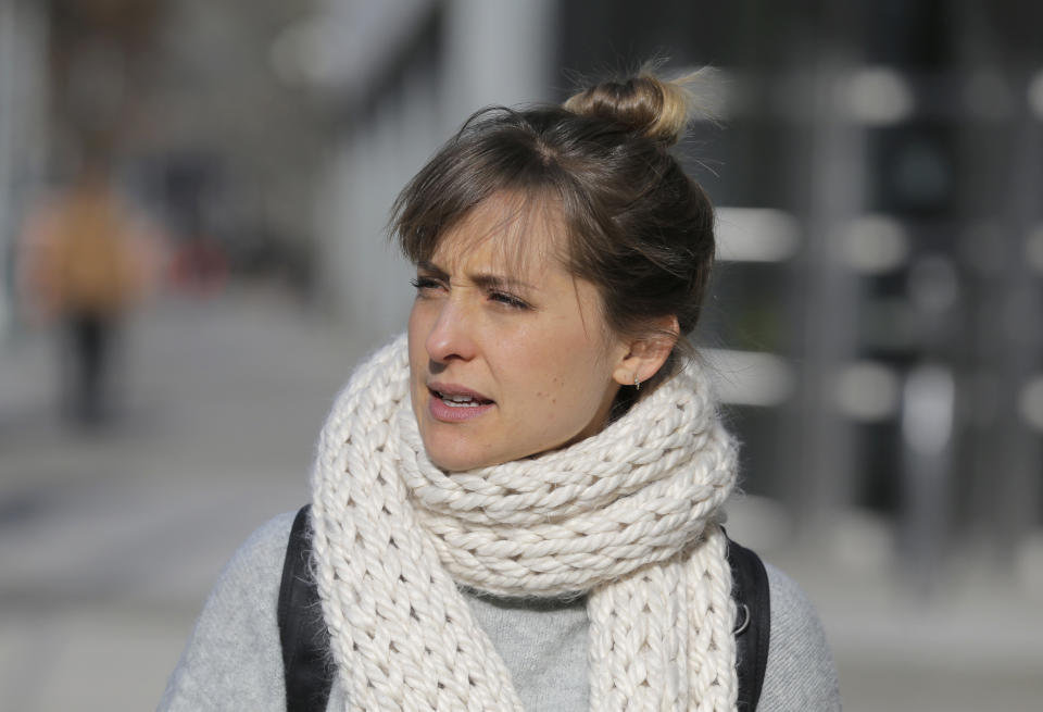 Television actress Allison Mack leaves federal court in New York, Thursday, Dec. 6, 2018.  Court papers say a trust funded by Seagram’s liquor fortune heiress Clare Bronfman is bankrolling the defense for her co-defendants in the sex-trafficking prosecution. They include the leader of the secretive upstate New York group NXIVM, Keith Raniere, and Mack.  All the defendants have pleaded not guilty to charges alleging that followers of the group were coerced into becoming sex slaves who were branded with Raniere's initials. (AP Photo/Seth Wenig)