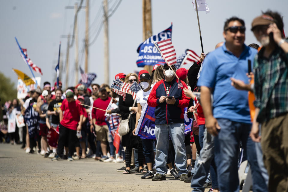People line the side of the road waiting for the motorcade with President Donald Trump to drive past on Thursday, May 14, 2020, in Allentown, Pa. (AP Photo/Matt Rourke)