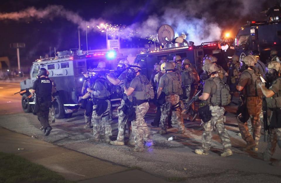 <div class="inline-image__caption"><p>Police advance while sending a volley of tear gas toward demonstrators protesting the killing of teenager Michael Brown on Aug. 17, 2014, in Ferguson, Missouri.</p></div> <div class="inline-image__credit">Scott Olson/Getty</div>