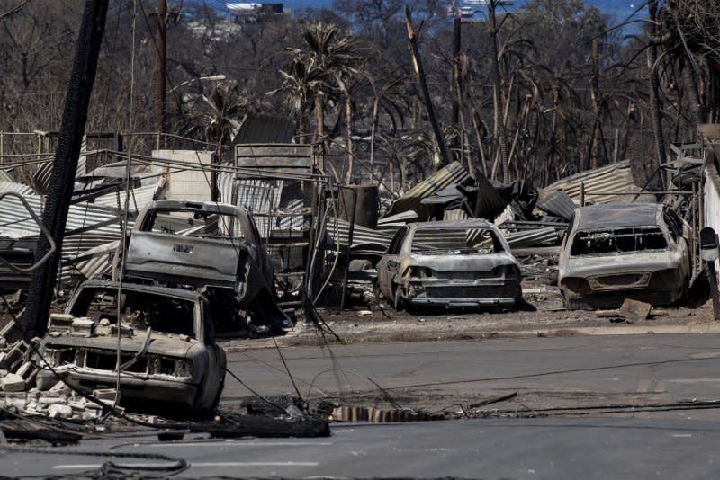 Charred cars and houses in Lahaina, Maui after a wildfire swept through the historic town last week. The latest death toll is at 99 with more than 1,000 people unaccounted for as FEMA Administrator Deanne Criswell told reporters Monday "nothing can prepare you for what I saw." Photo by Etienne Laurent/EPA-EFE/