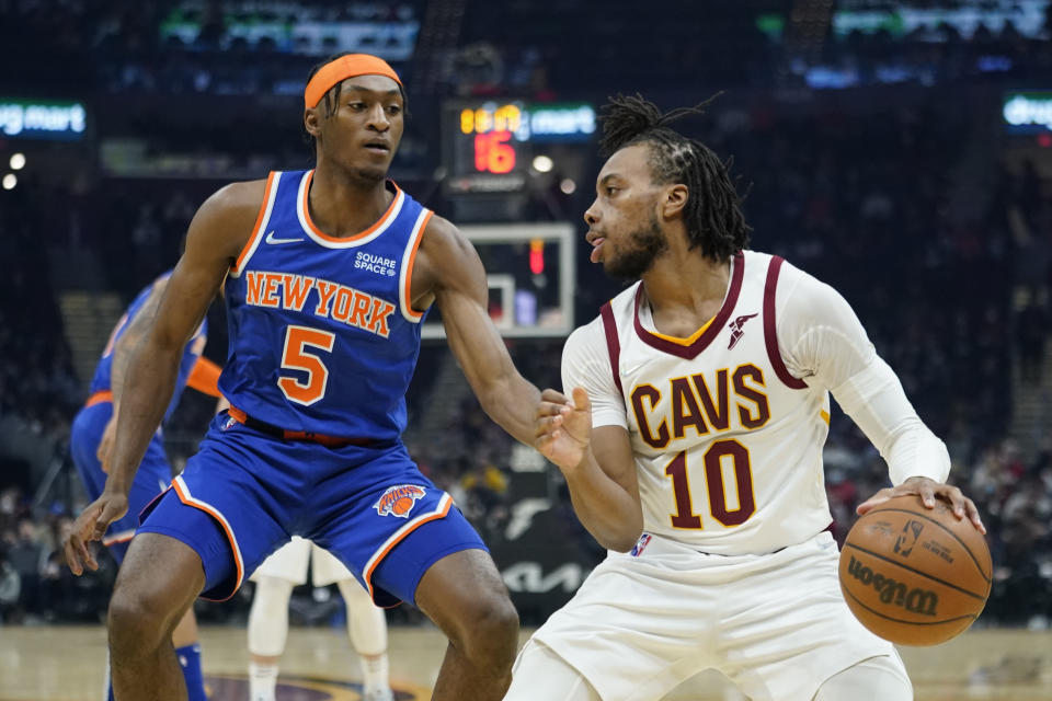 Cleveland Cavaliers' Darius Garland (10) drives against New York Knicks' Immanuel Quickley (5) in the first half of an NBA basketball game, Monday, Jan. 24, 2022, in Cleveland. (AP Photo/Tony Dejak)