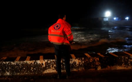 A member of Civil Protection looks at the sea before the arrival of Hurricane Lorenzo near Sao Mateus