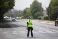 A police officer gestures towards cars as she tries to control traffic during a power outage in Sarajevo, Bosnia, Friday, June 21, 2024.(AP Photo/Armin Durgut)