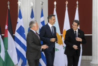 Jordan's King Abdullah II, left, Greece's Prime Minister Kyriakos Mitsotakis, center, and Cyprus' President Nikos Anastasiades make their way for a meeting in Athens, on Wednesday, July 28, 2021. Greece is hosting a one-day trilateral meeting of the three leaders. (AP Photo/Yorgos Karahalis)