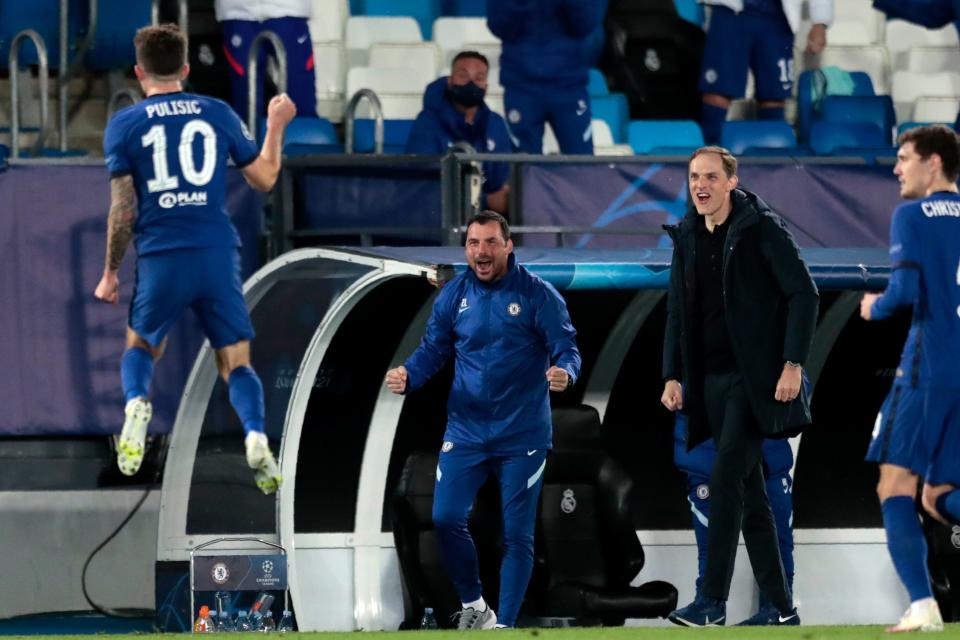 Chelsea's head coach Thomas Tuchel, second from right, reacts as Chelsea's Christian Pulisic, left, celebrates after scoring the opening goal during the Champions League semifinal first leg match against Real Madrid.