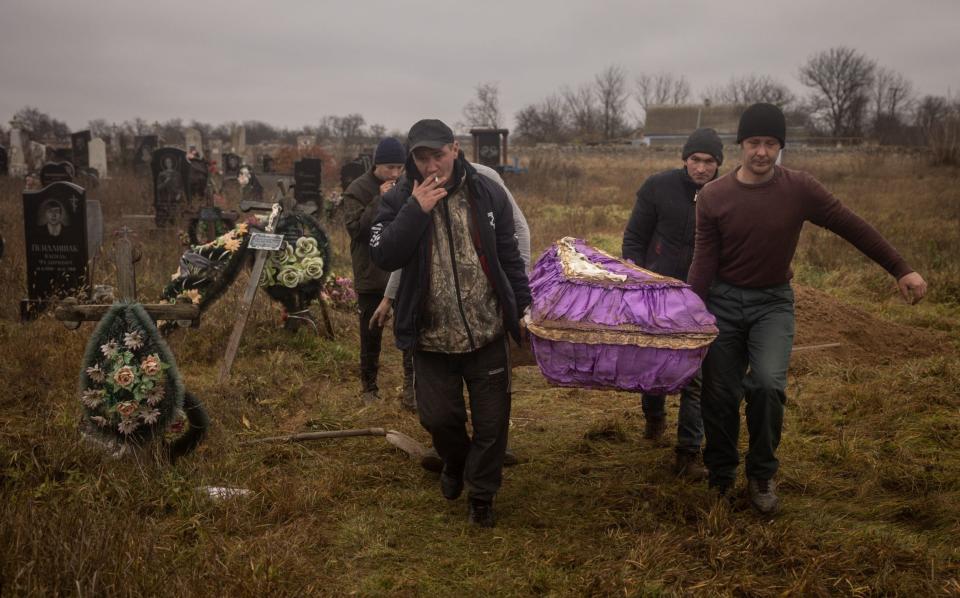 Local residents carry the coffin of a 16-year-old girl after forensic inspection - Chris McGrath/Getty Images