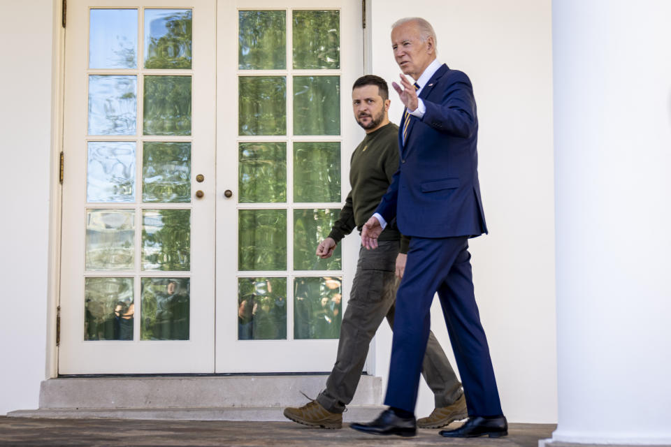 President Joe Biden walks through the Colonnade with Ukraine's President Volodymyr Zelenskyy to the Oval Office at the White House in Washington, Wednesday, Dec. 21, 2022. (AP Photo/Andrew Harnik)
