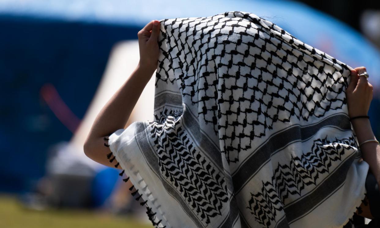 <span>An unknown person wearing a keffiyeh. Two Black Star Pastry bakery employees have launched a discrimination case over their dismissal, after they both wore the traditional scarf in support of Palestine at work.</span><span>Photograph: Stacey Newman/Rex/Shutterstock</span>