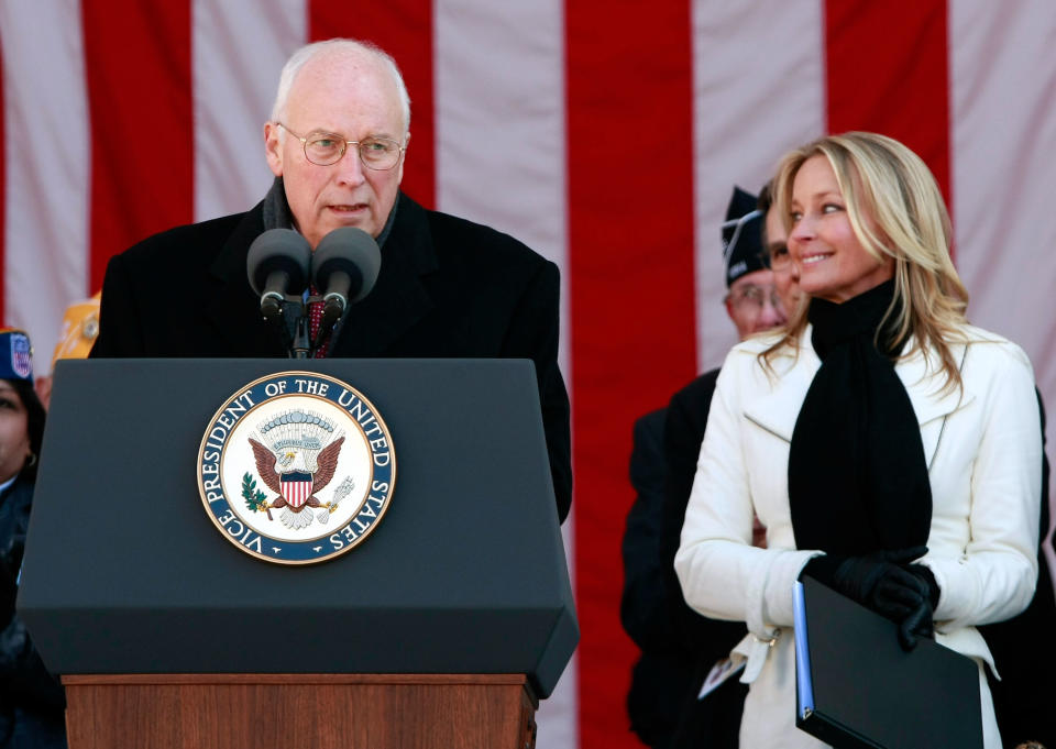 Vice President Dick Cheney speaks as actress Bo Derek, the mistress of ceremonies, looks on during Veterans Day ceremonies at Arlington National Cemetery November 11, 2008 in Arlington, Virginia.  (Photo by Win McNamee/Getty Images)