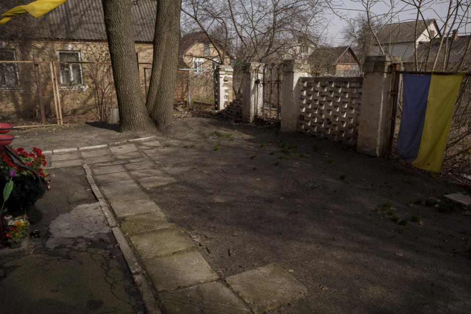 The empty plot in a courtyard where in 2022 Russian forces left the dead bodies of eight men, photographed from the same angle than a photo them taken by AP photographer Vadim Ghirda in April 2022 in Bucha, Ukraine, Saturday March 30, 2024. The photo showed bodies of men, some with their hands tied behind their backs, lying on the ground. It was part of a series of images by Associated Press photographers that was awarded the 2023 Pulitzer Prize for Breaking News Photography. (AP Photo/Vadim Ghirda)