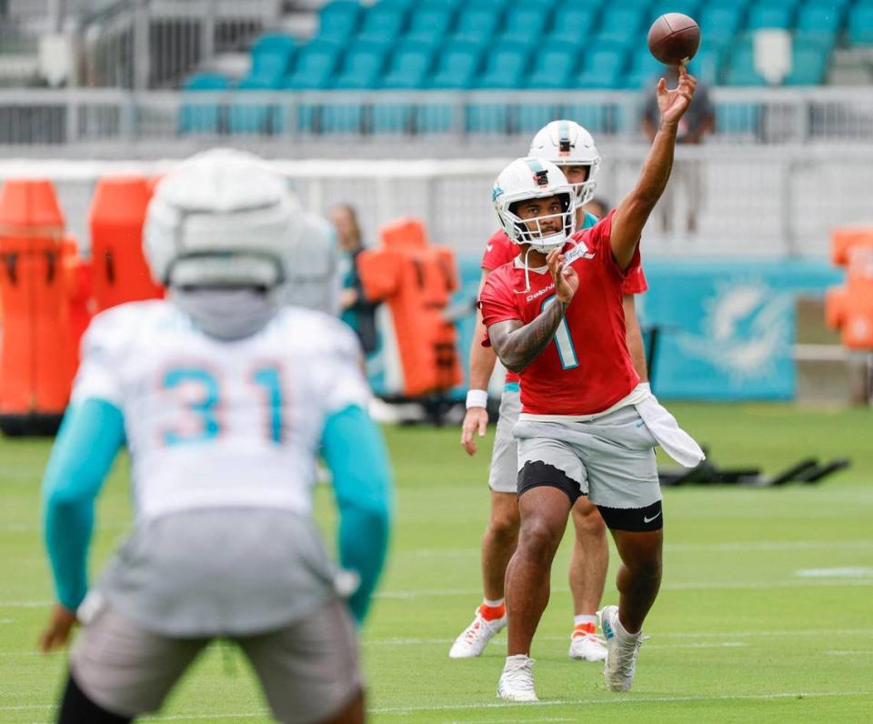 Miami Dolphins quarterback Tua Tagovailoa (1) passes the ball to Miami Dolphins running back Raheem Mostert (31) during practice at the Baptist Health Training Complex in Miami Gardens, Florida on Wednesday, July 26, 2023.