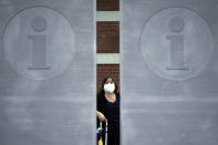 A woman wearing a face mask to help curb the spread of the coronavirus walks Monday, July 13, 2020, in Tokyo. The Japanese capital has confirmed more than 100 new coronavirus infections on Monday. (AP Photo/Eugene Hoshiko)