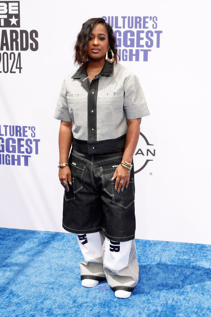 Rapsody stands on the red carpet wearing a two-toned outfit with oversized pants and matching top at the BET Awards 2024