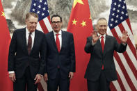 Chinese Vice Premier Liu He, right, gestures as U.S. Treasury Secretary Steven Mnuchin, center, chats with his Trade Representative Robert Lighthizer, left, before they proceed to their meeting at the Diaoyutai State Guesthouse in Beijing, Wednesday, May 1, 2019. (AP Photo/Andy Wong, Pool)