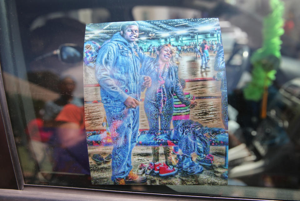 ST. LOUIS, MO - AUGUST 12: Lesley McSpadden the mother of slain teenager Michael Brown shows a painting of her and her son through her car window as she leaves a press conference held by civil rights leader Rev. Al Sharpton on August 12, 2014 in St. Louis, Missouri. Brown was shot and killed by a police officer on Saturday in suburban Ferguson, Missouri. Sharpton and Browns family were calling for order following riots and skirmishes with police over the past two nights in Ferguson by demonstrators angry over the shooting.   (Photo by Scott Olson/Getty Images)