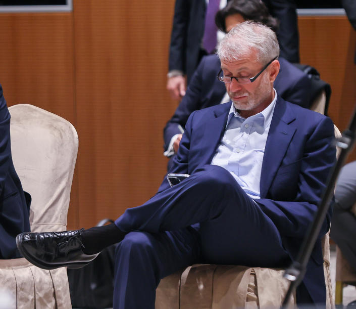 Russian businessman Roman Abramovich sits in a chair as he attends peace talks between Russia and Ukraine.