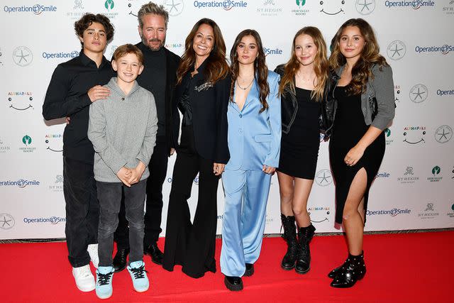 <p>Alex Goodlett/Getty Images</p> Brooke Burke, fiancé Scott Rigsby, and children in 2023