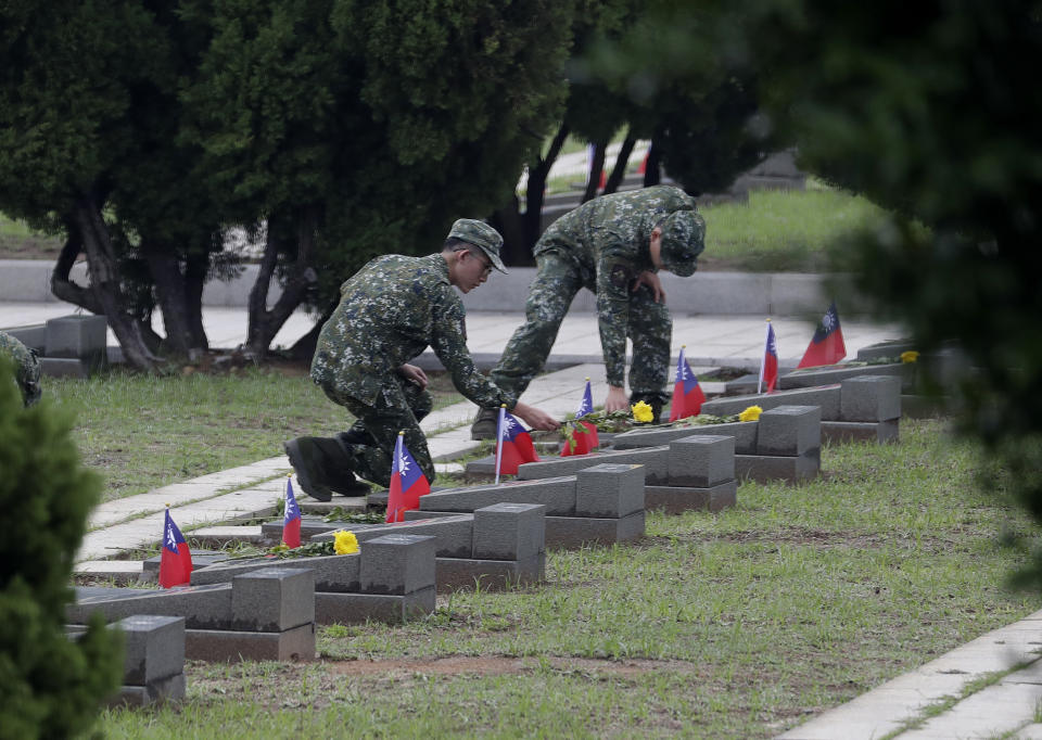 Soldiers salute to the fallen during a ceremony commemorating the 65th anniversary of deadly attack by China on Kinmen island, in Kinmen, Taiwan, Wednesday, Aug. 23, 2023. (AP Photo/Chiang Ying-ying)