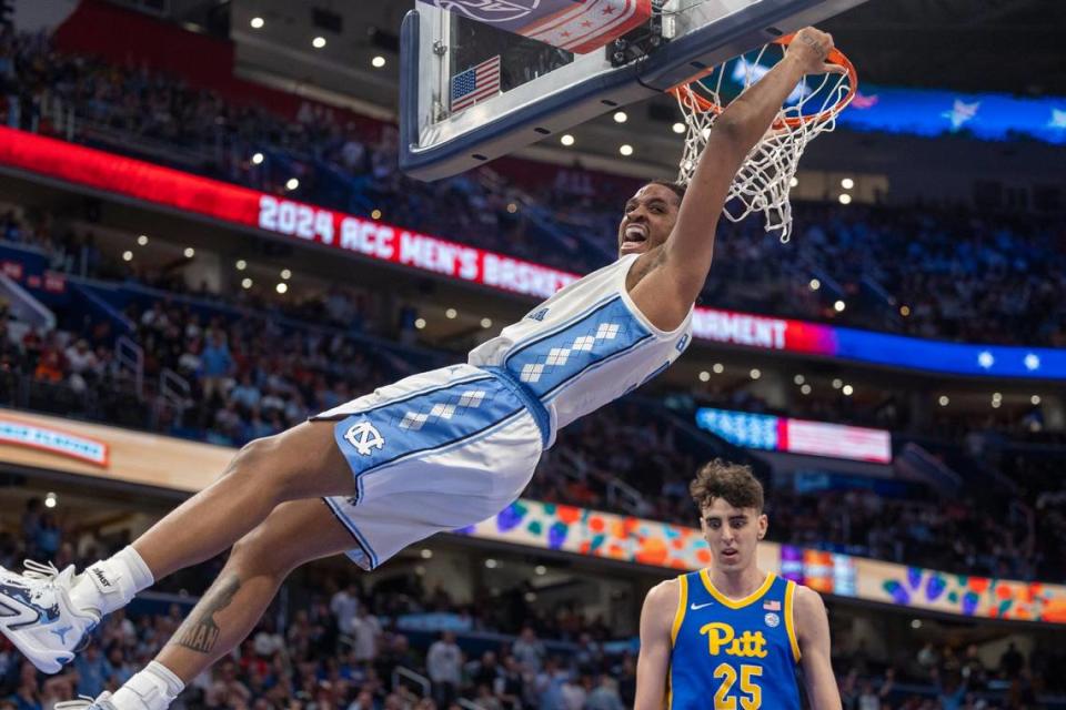 North Carolina’s Armando Bacot (5) hangs on the rim after a dunk over Pittsburgh’s Guillermo Diaz Graham (25) during the second half in the semi-finals of the ACC Men’s Basketball Tournament at Capitol One Arena on Friday, March 15, 2024 in Washington, D.C. Bacot scored 19 points in the Tar Heels’ victory.