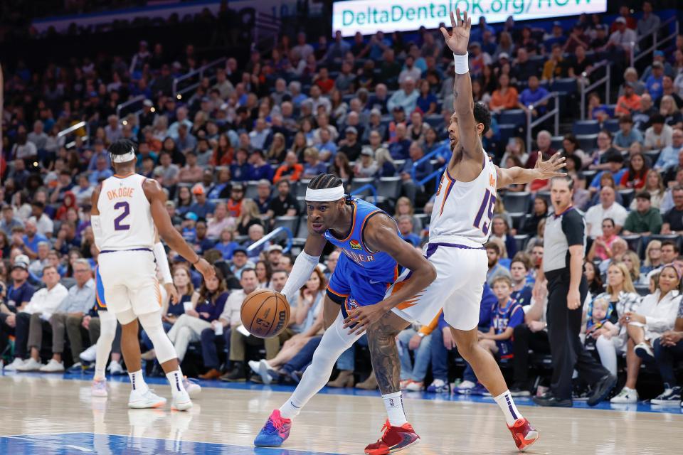 Oklahoma City Thunder guard Shai Gilgeous-Alexander (2) fights for position against Phoenix Suns guard Cameron Payne (15) during the first quarter at Paycom Center on April 02, 2023, in Oklahoma City.