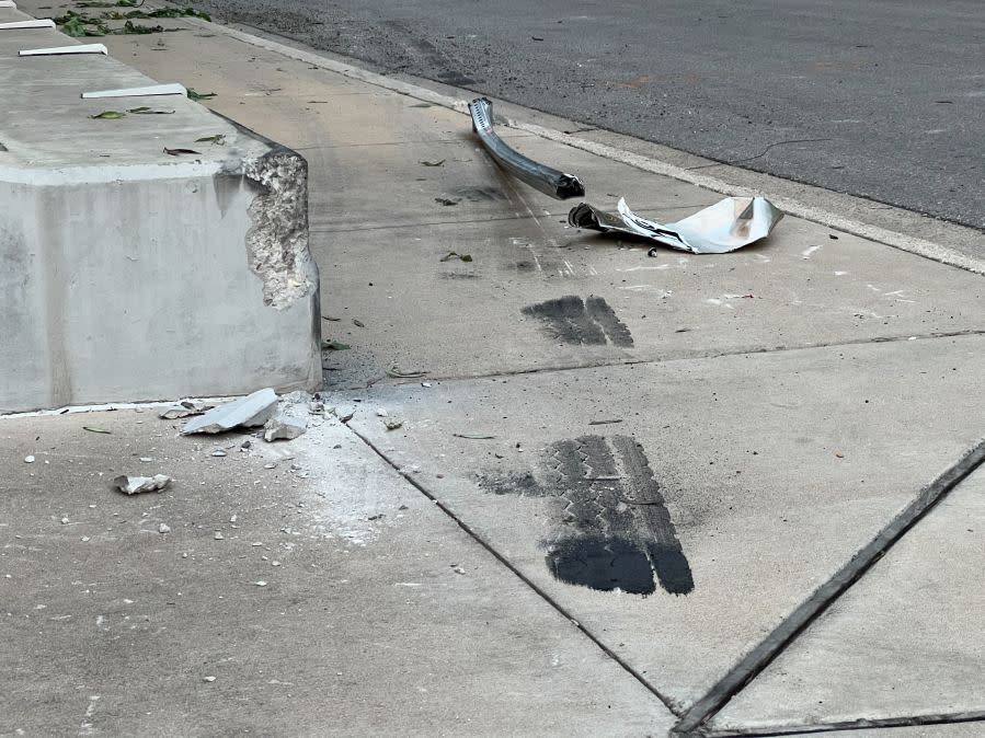 Damage to cars, street signs, etc. along East 9th Street near Embassy Drive after an 18-wheeler crashed into 10 parked vehicles overnight April 22, 2024 (KXAN Photo/Todd Bailey)