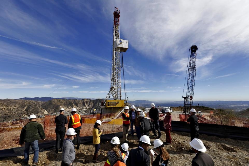 Several people stand around a relief well being drilled at Aliso Canyon in December 2015.