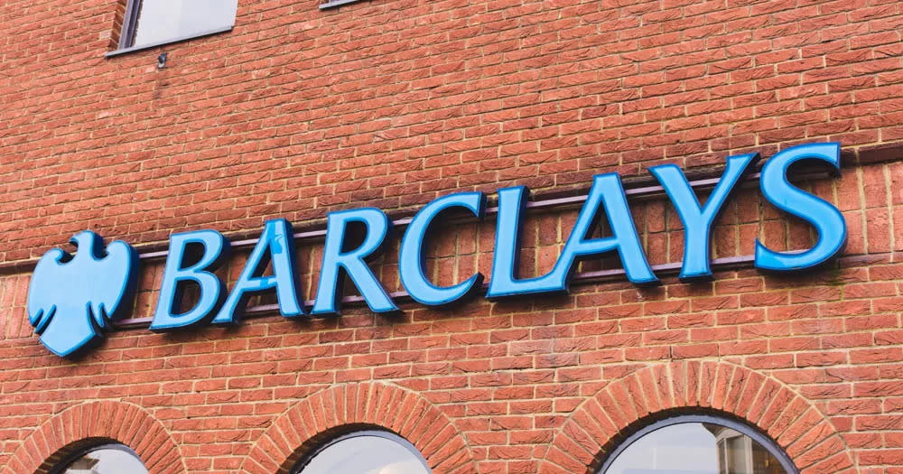 Barclays has paid out £21,500 to Christian group Core Issues Trust. The image shows the front of a Barclays bank. The building is red brick with arched windows. The Barclays' sign is blue lettering with the graphic of an eagle.