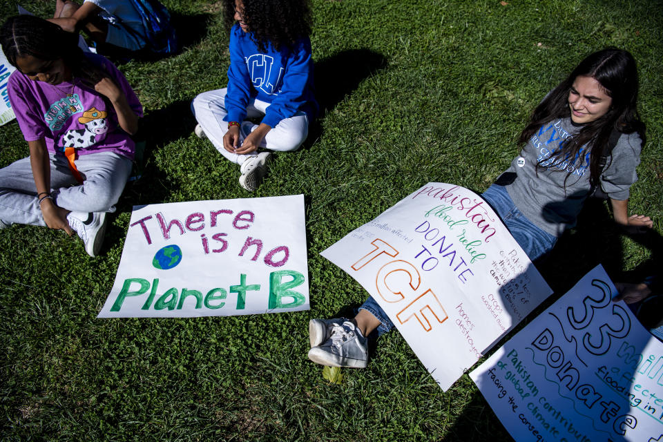 FILE - Giselle Barker, 14, from left, Azuri Brown, 15, and Charlotte E., 17, listen to speakers for the Global Climate Strike protests in New York on Sept. 23, 2022. The annual Climate Week, which coincides with the U.N. General Assembly, kicks off Sunday, Sept. 17, 2023, with tens of thousands of people expected in the “March to End Fossil Fuels” Manhattan rally, one of hundreds of worldwide protests. (AP Photo/Brittainy Newman, File)