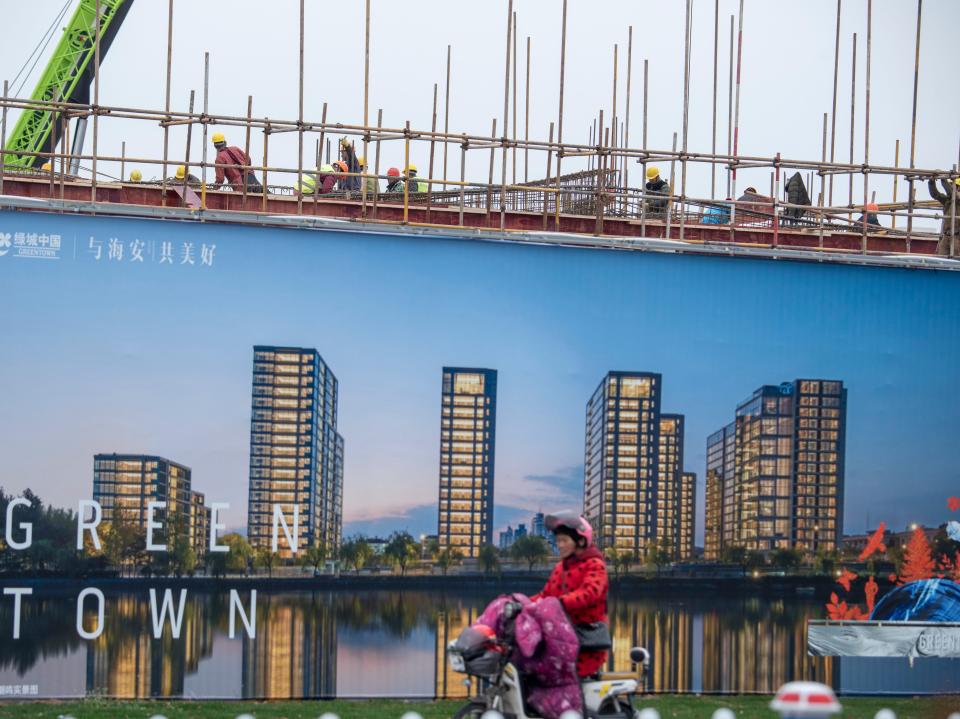 Workers at the construction site of a residential block belonging to the property developer Greentown China on March 3, 2021 in Nantong, Jiangsu Province of China.