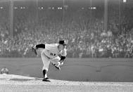 FILE - In this Oct. 12, 1960 file photo, New York Yankees pitcher Whitey Ford throws during the 6th game of the World Series against the Pittsburgh Pirates in Pittsburgh. A family member tells The Associated Press on Friday, Oct. 9, 2020 that Ford died at his Long Island home Thursday night. (AP Photo, File )