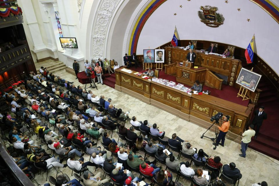 National Constituent Assembly members attend a session in Caracas, Venezuela, Tuesday, April 2, 2019. Lawmakers loyal to President Nicolas Maduro considered whether to strip National Assembly leader Juan Guaido of immunity on Tuesday in a move that would pave the way to prosecute and potentially arrest him for allegedly violating the constitution after declaring himself interim president. (AP Photo/Ariana Cubillos)