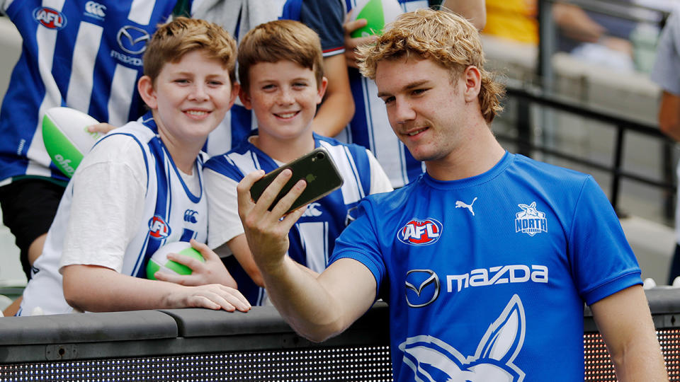 Fans are back at the footy in Melbourne, as Jason Horne-Francis of the Kangaroos takes a selfie with fans before their match against Hawthorn last weekend. (Photo by Dylan Burns/AFL Photos via Getty Images)