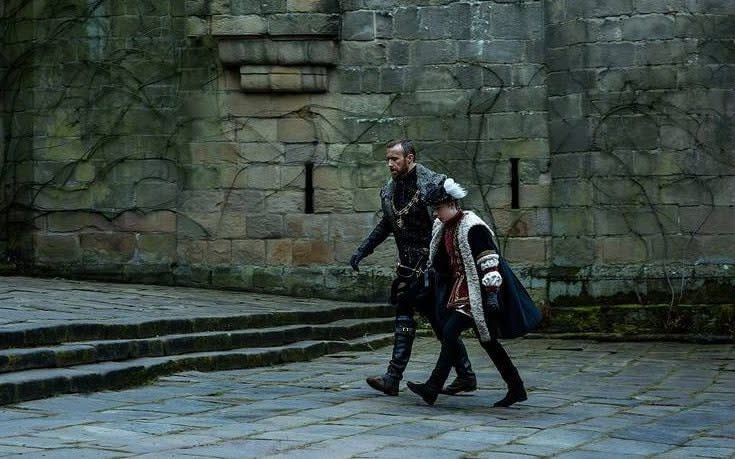 John Heffernan as Lord Protector Edward Seymour and Oliver Zetterström as King Edward VI crossing a courtyard in the Starz show Becoming Elizabeth - Starz