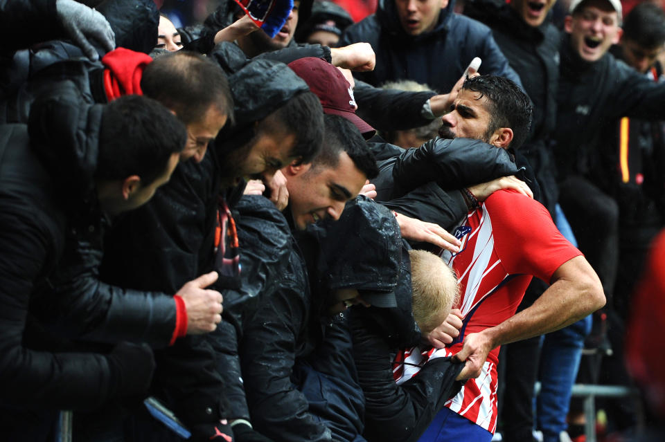 Diego Costa celebrates with Atletico Madrid fans after scoring in his first La Liga match back with the Spanish club. (Getty)