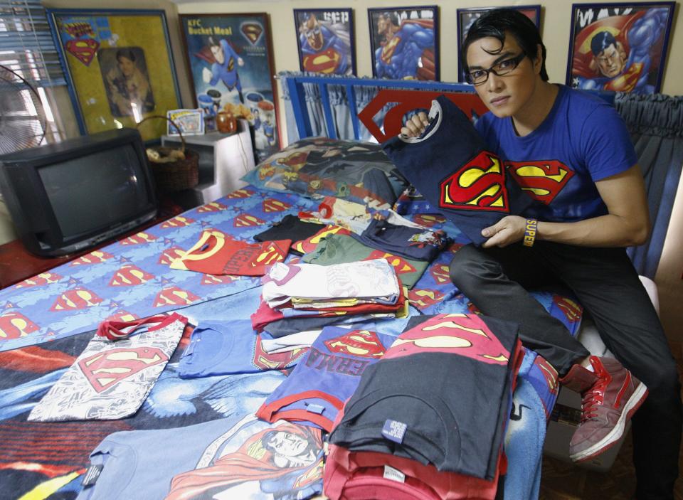 Herbert Chavez shows off his Superman shirt collection, some of which were made by him, inside his bedroom in Calamba Laguna, south of Manila
