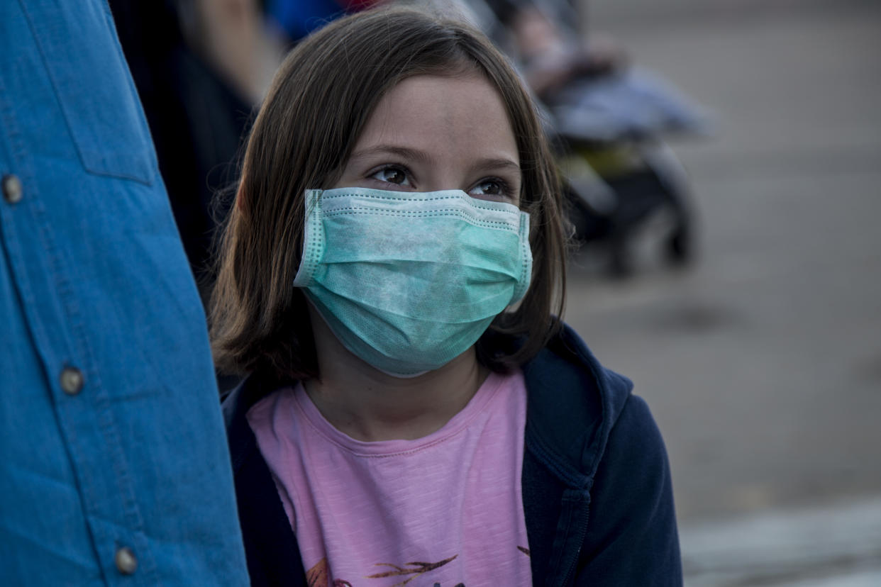 KHARTOUM, SUDAN - APRIL 22: A Turkish girl wears a face mask as a preventive measure against the coronavirus (COVID-19) pandemic as Turkish citizens arrive at Khartoum International Airport ahead of a flight to Turkey as part of the evacuation process due to the pandemic in Khartoum, Sudan on April 22, 2020. Turkey evacuates 363 citizens from Sudan upon their application to the embassy amid the novel coronavirus pandemic. (Photo by Mahmoud Hjaj/Anadolu Agency via Getty Images)