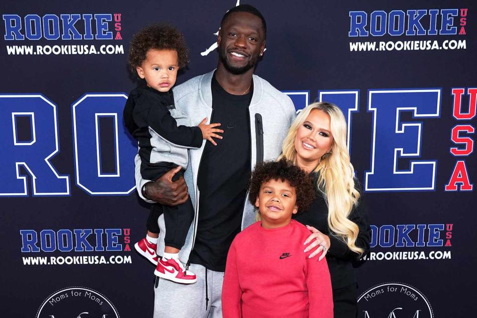 <p>Bennett Raglin/Getty</p> Julius Randle and his wife Kendra alongside their two kids.