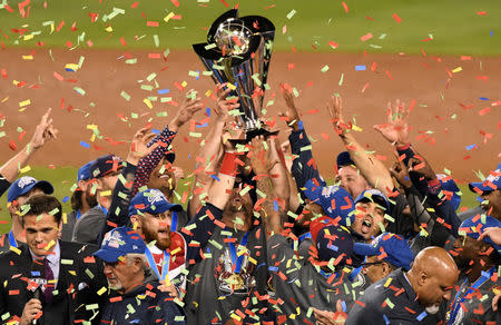 Mar 22, 2017; Los Angeles, CA, USA; United State players hold up the championship trophy after defeating Puerto Rico in the final of the 2017 World Baseball Classic at Dodger Stadium. Mandatory Credit: Robert Hanashiro-USA TODAY Sports