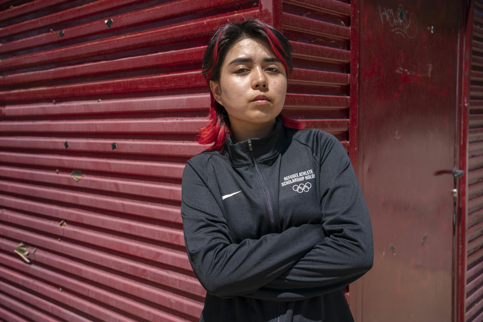 Manizha Talash, originally from Afghanistan, stands for a portrait outside the Parish of the Inmaculado Corazon de Maria in Madrid, Spain, where she was granted asylum, June 11, 2024. The 21-year-old will compete with the Refugee Olympic Team for the Olympic Games in Paris, where breaking will be included for the first time. (AP Photo/Andrea Comas)