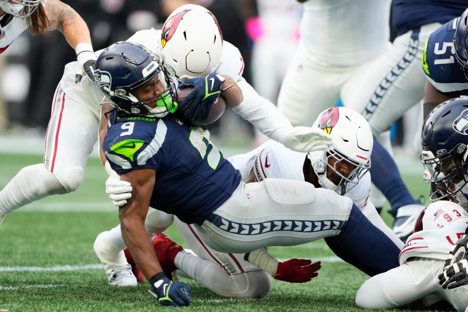 Seattle Seahawks running back Kenneth Walker III (9) is tackled by a host of Arizona Cardinals defenders Sunday in Seattle.