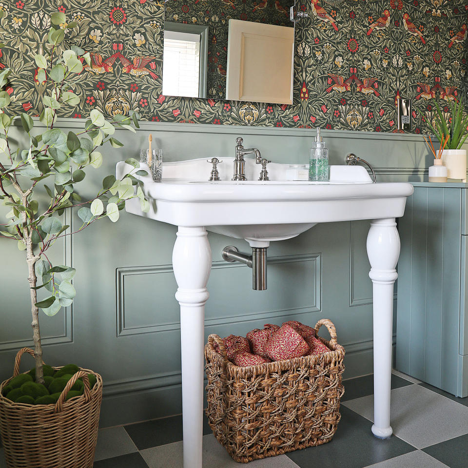 Wallpaper in green bathroom with white sink